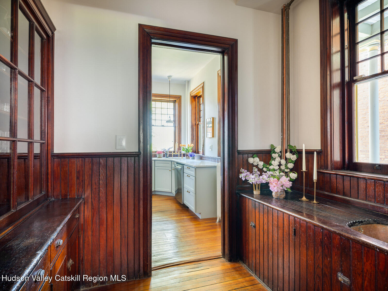 164 Grand Street Newburgh, NY 12550 - Photo 16 of 59 a view of a hallway to a livingroom with wooden floor and furniture