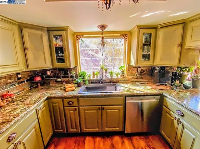 a kitchen with a sink stove and cabinets