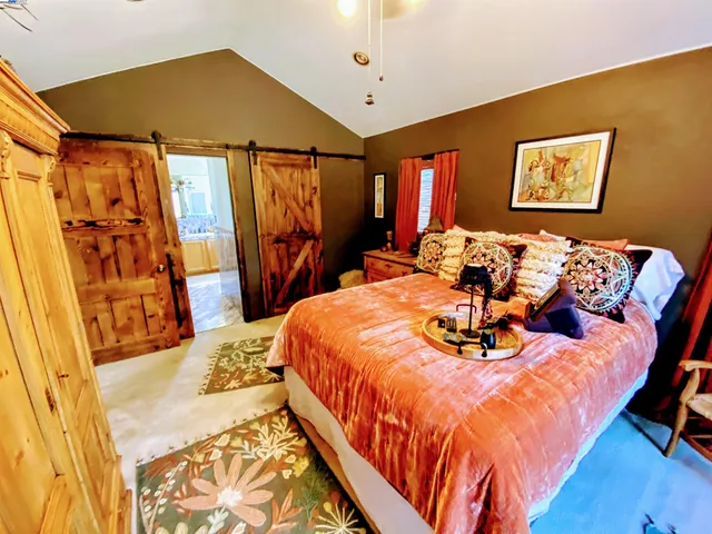 a bed sitting in a bedroom next to a window