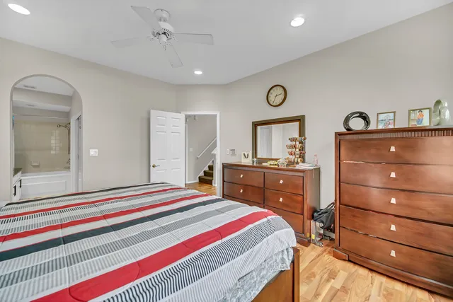 a bedroom with a bed and a dresser in it