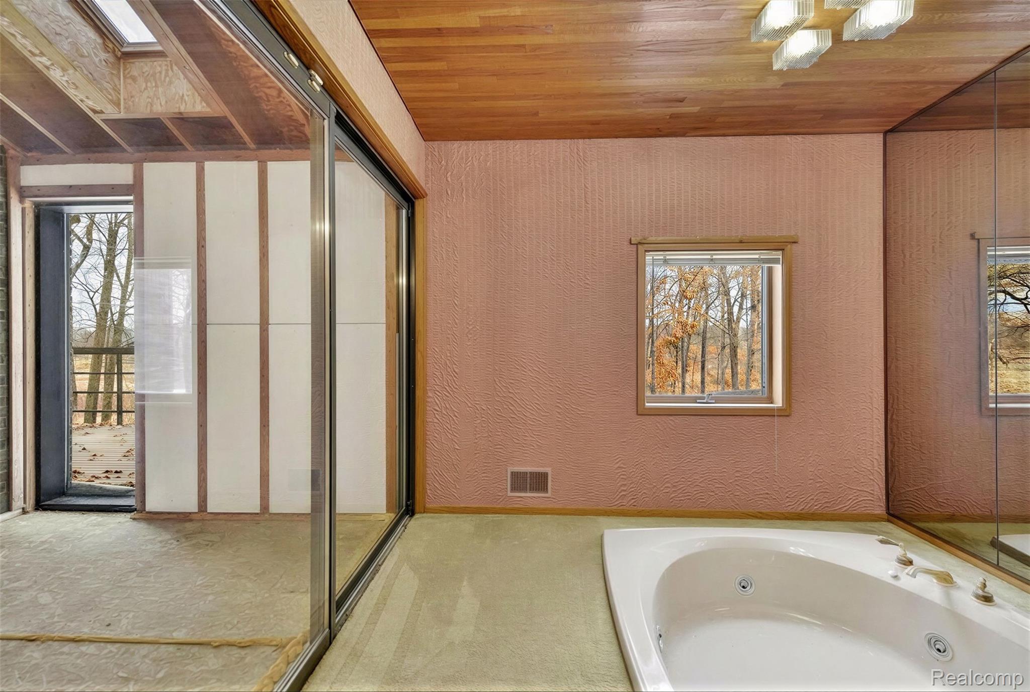 2551 Patterson Lk Road Pinckney, MI 48169 - Photo 57 of 95 Primary Bath and Sunken Tub. Hot tub room to the left.