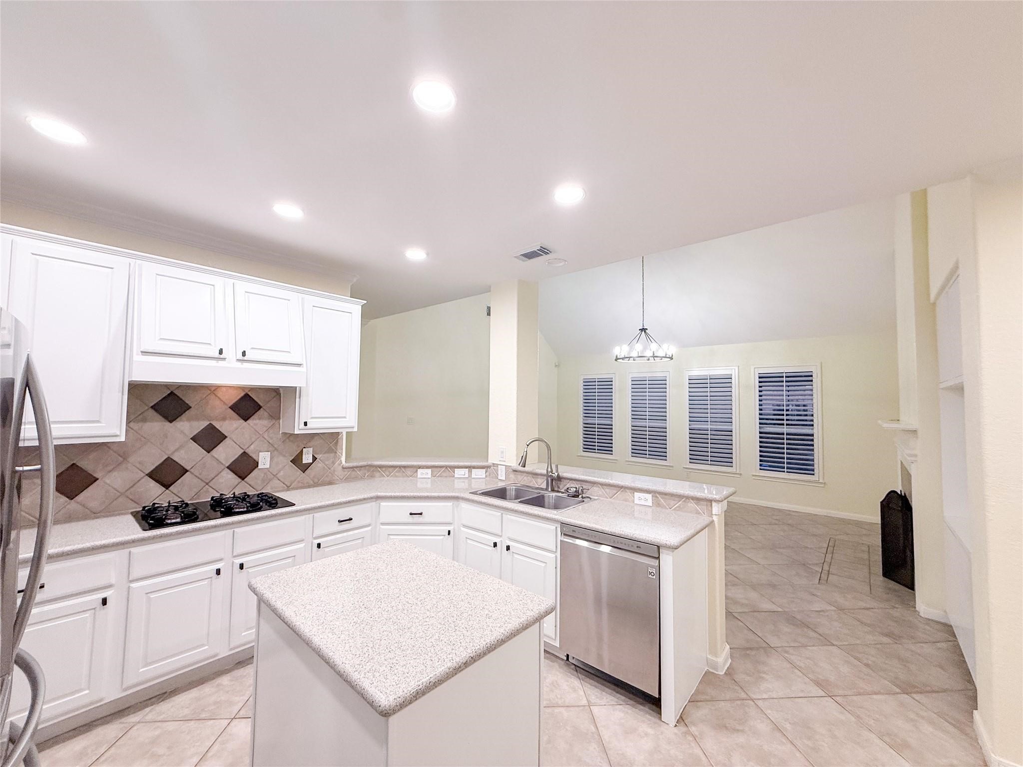 79 West Shale Creek Circle Spring, TX 77382 - Photo 14 of 29 a kitchen with a sink stove and cabinets