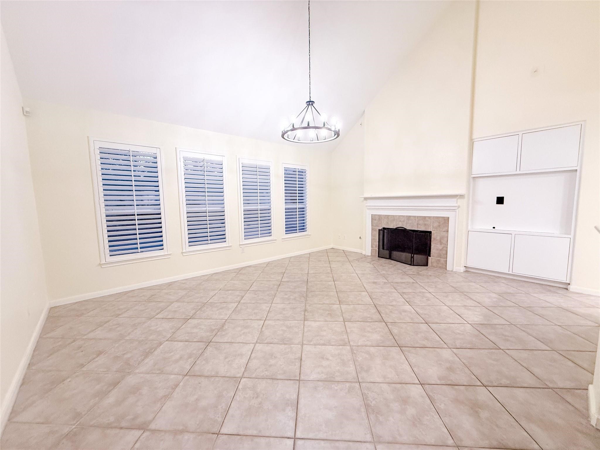 79 West Shale Creek Circle Spring, TX 77382 - Photo 18 of 29 a view of empty room with fireplace and window