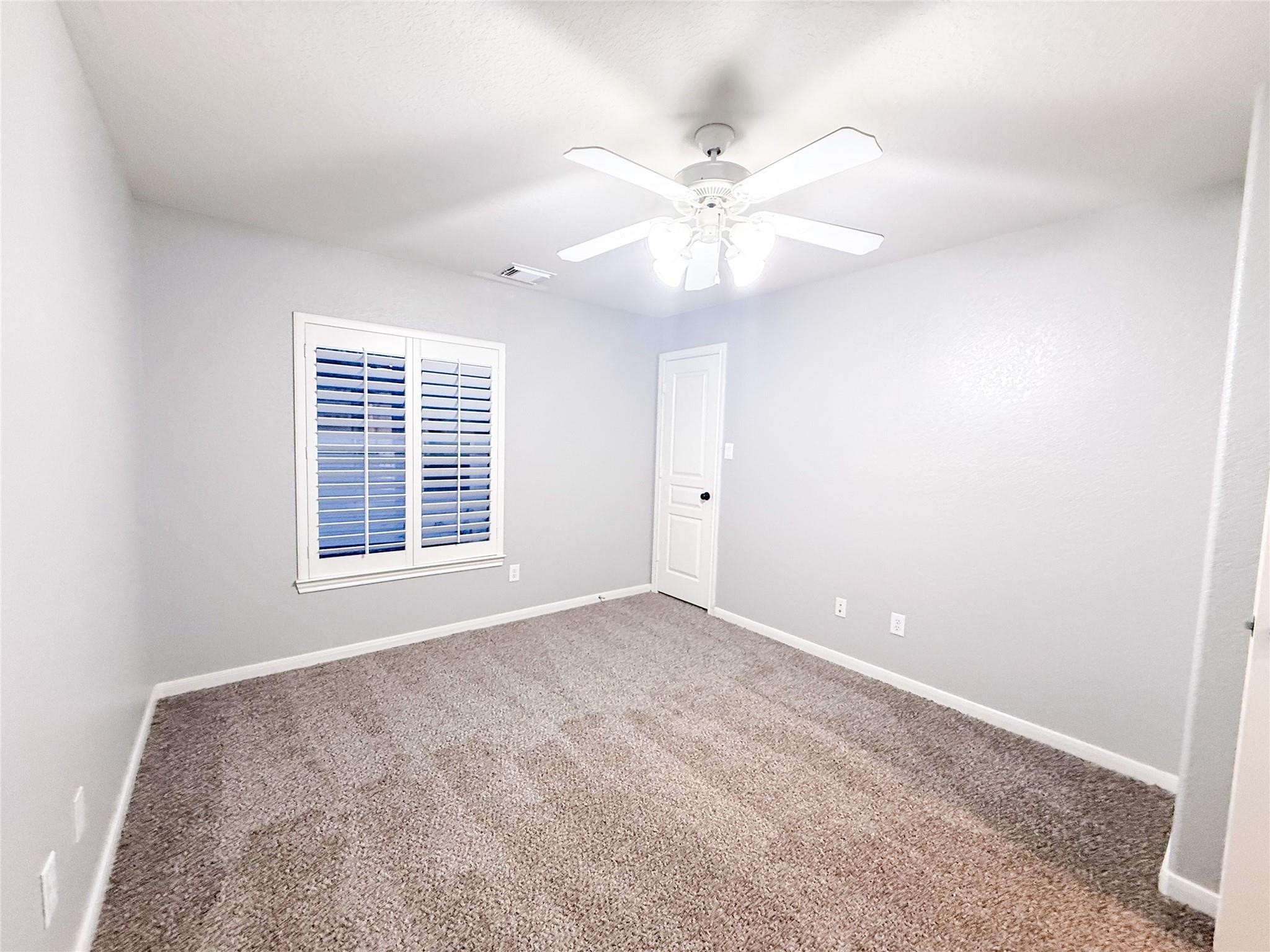 79 West Shale Creek Circle Spring, TX 77382 - Photo 27 of 29 an empty room with windows and fan