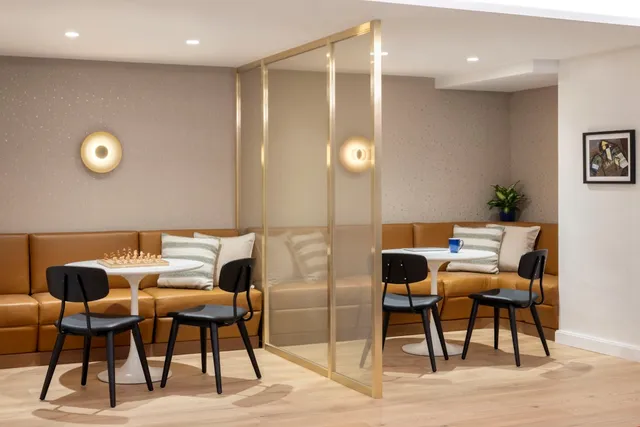 a outdoor dining space with chairs and chandelier