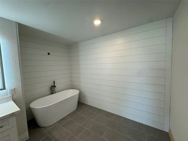 a bathroom with a bathtub and shower