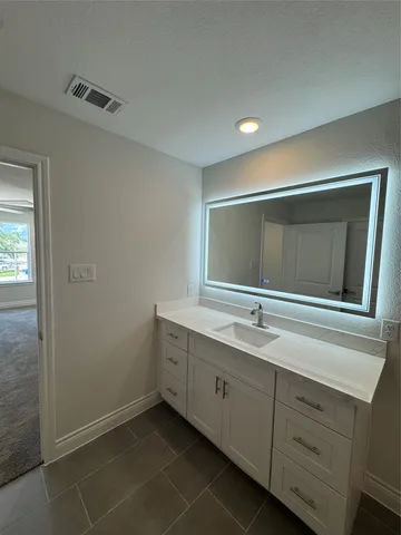 a bathroom with a double vanity sink and mirror