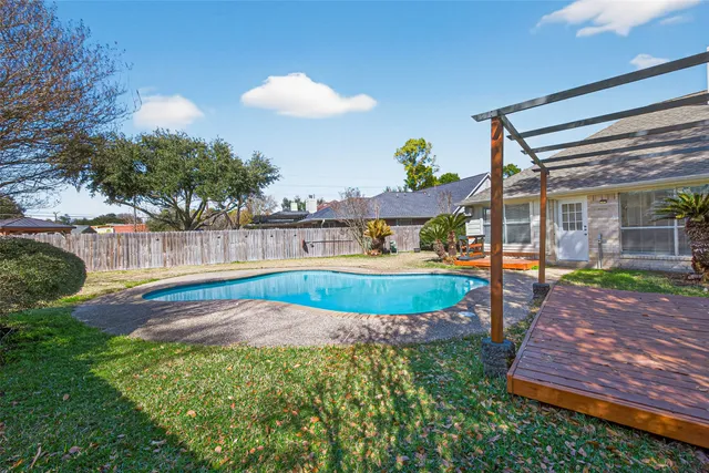 a view of a backyard with swimming pool