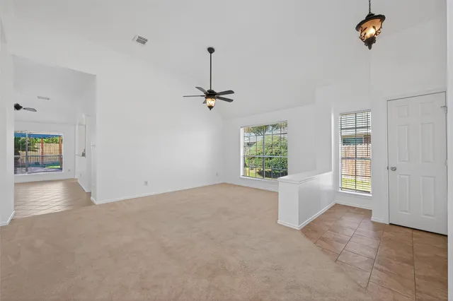 an empty room with windows and closet