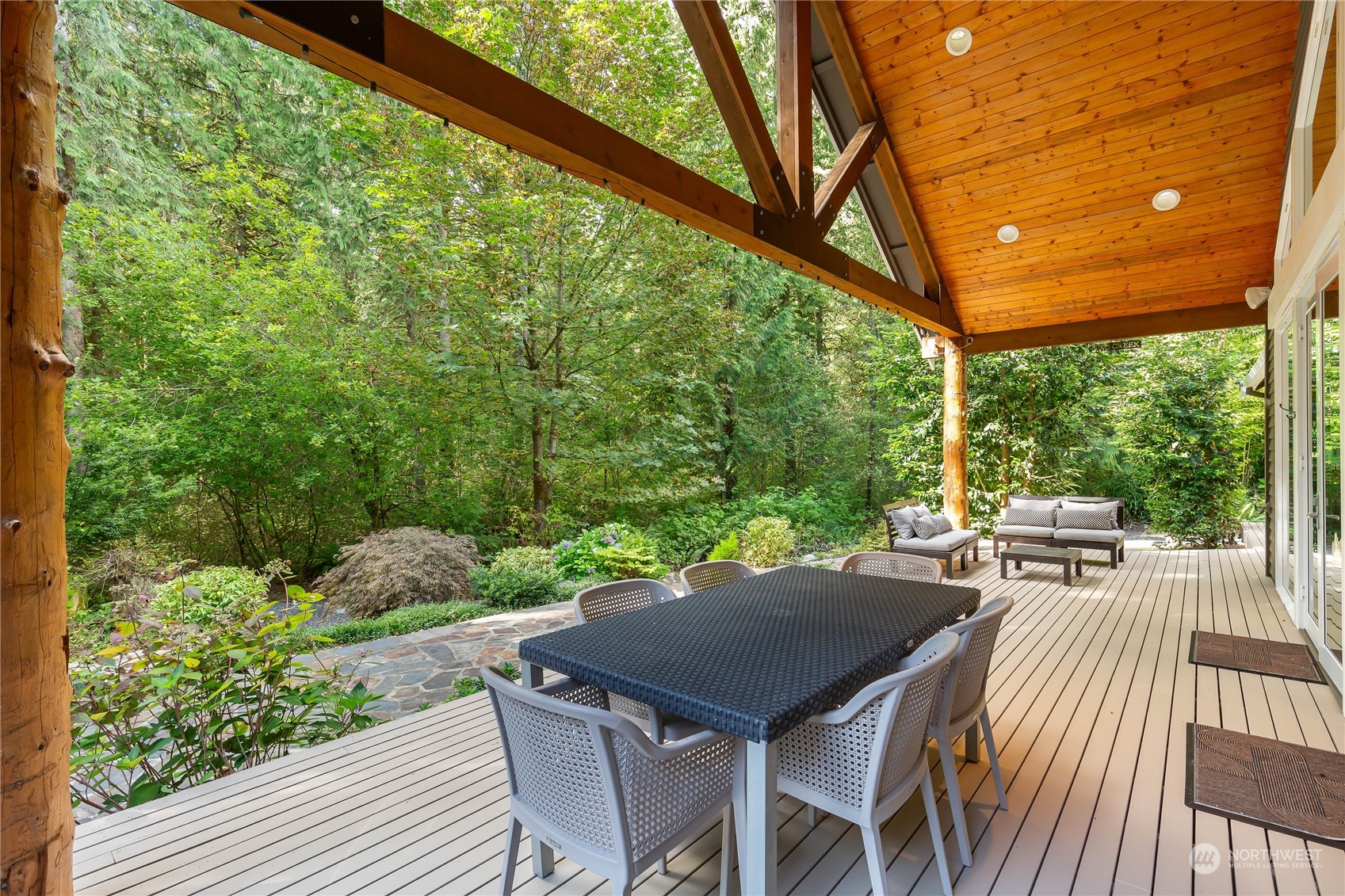 11417 Kelly Road Northeast Carnation, WA 98014 - Photo 15 of 38 a view of a patio with table and chairs and potted plants