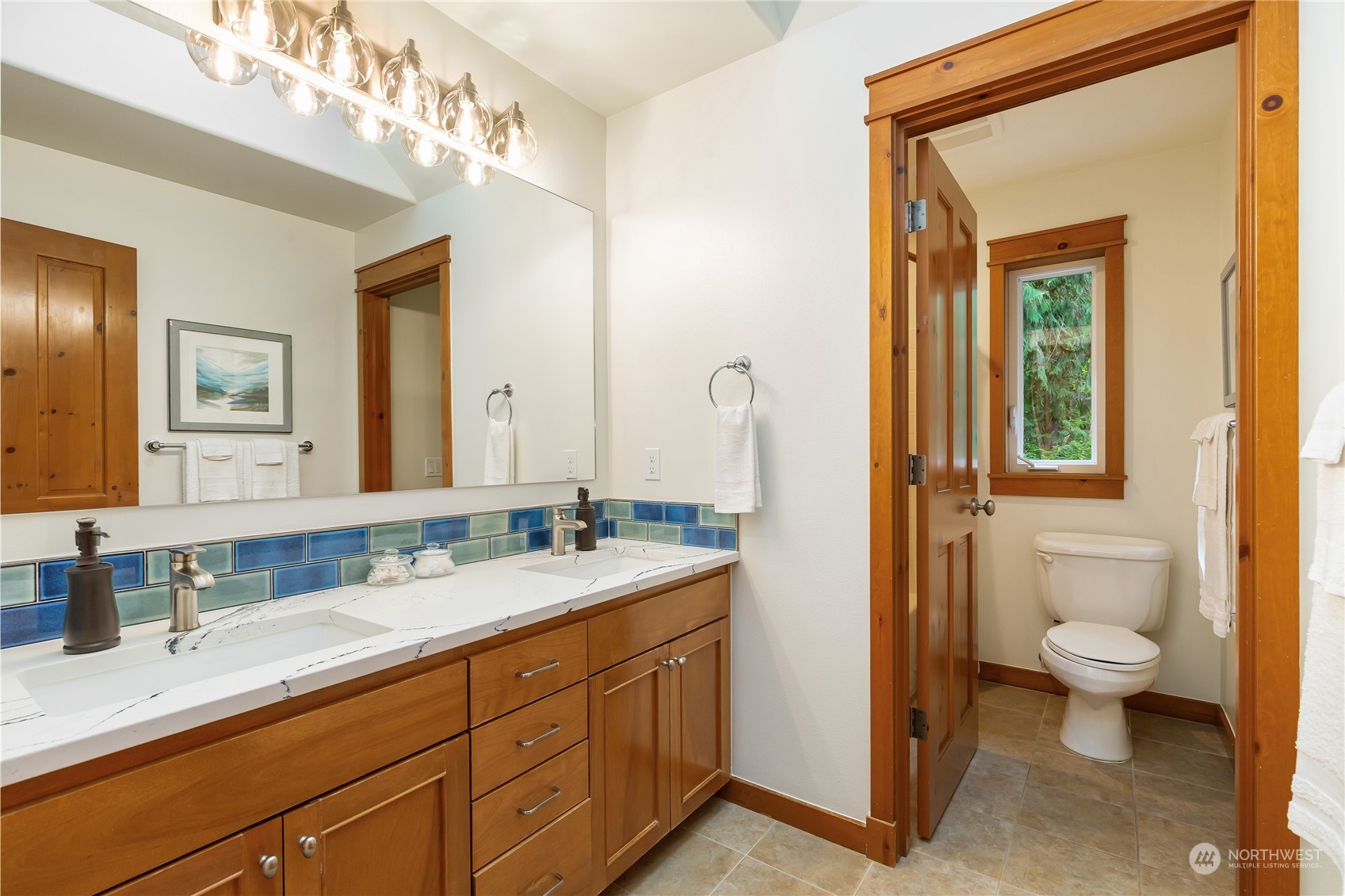 11417 Kelly Road Northeast Carnation, WA 98014 - Photo 26 of 38 a spacious bathroom with a granite countertop sink toilet and mirror