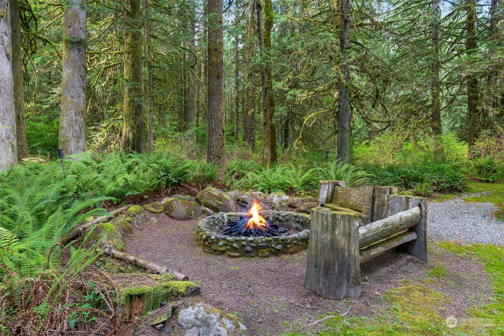 11417 Kelly Road Northeast Carnation, WA 98014 - Photo 32 of 38 a view of a backyard with couches under an umbrella