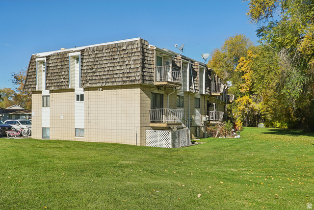 645 Swenson Avenue, Unit 3 Springville, UT 84663 - Photo 9 of 9 View of home's exterior with a balcony, mansard roof, and a yard