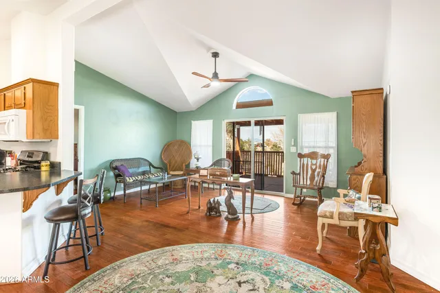 a living room with fireplace furniture and a large window