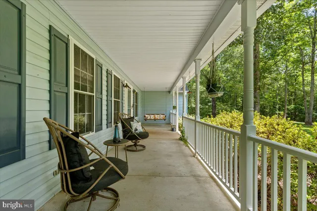 a living room with furniture a flat screen tv and a large window