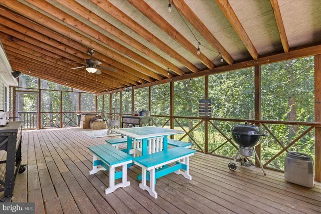 a kitchen with stainless steel appliances kitchen island granite countertop a refrigerator a stove a sink dishwasher a couches with the couches and wooden floor