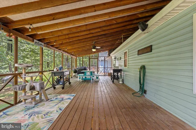 a large open kitchen with granite countertop a refrigerator a stove top oven a dining table and chairs