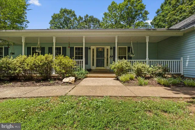 a front view of a house with a yard table and chairs