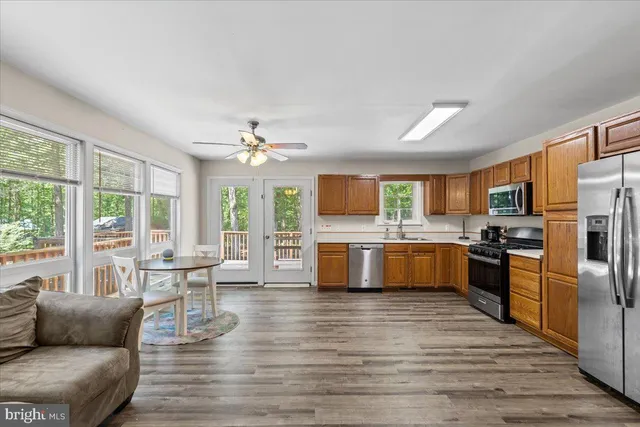 a view of a lush green forest with trees and houses