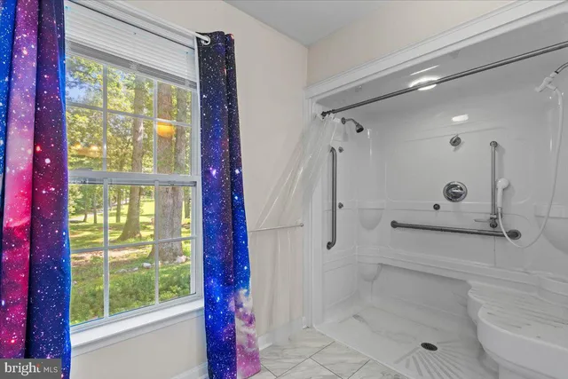 a view of a house with a yard and tree