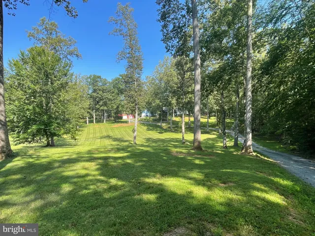 a view of a dining room with furniture wooden floor and chandelier
