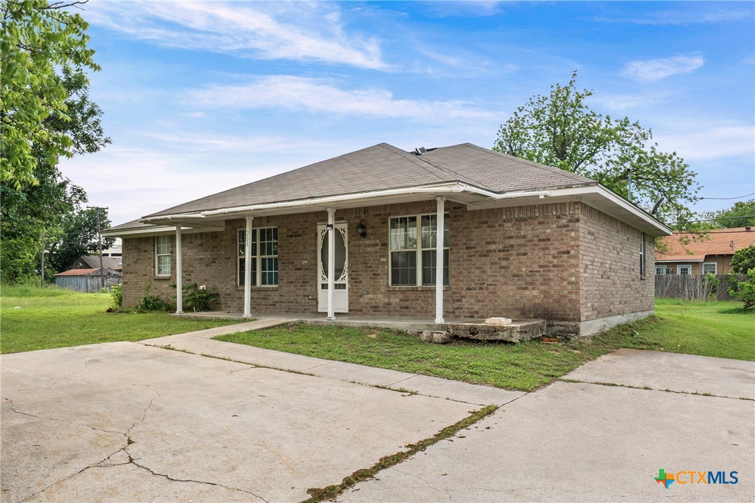 208 North 8th Street Temple, TX 76501 - Photo 3 of 13 a front view of a house with a yard and garage