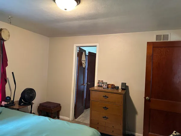 a bedroom with a bed and cabinets