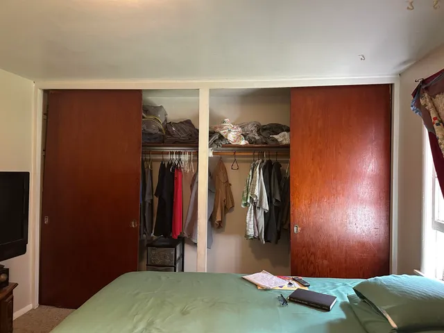 a room with a closet and a mirror