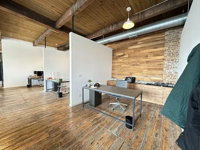 a room with wooden floor and furniture
