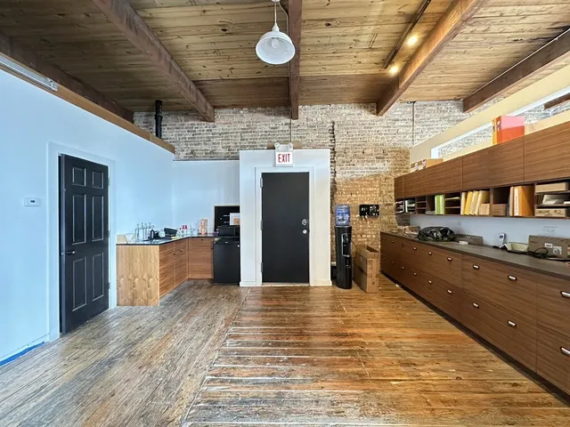 a kitchen with stainless steel appliances wooden cabinets a sink and a refrigerator