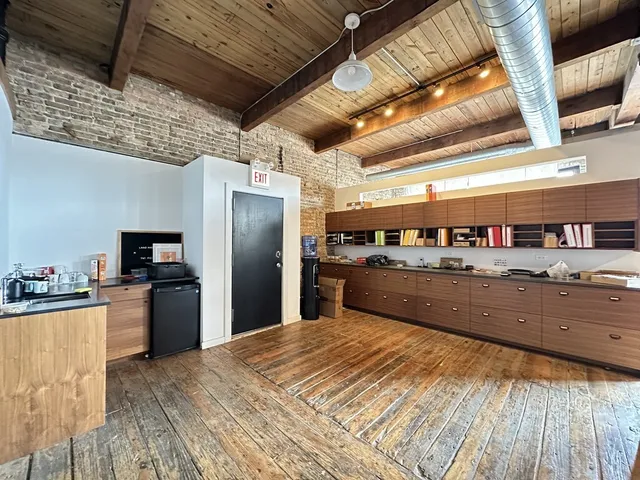 a kitchen with refrigerator and window