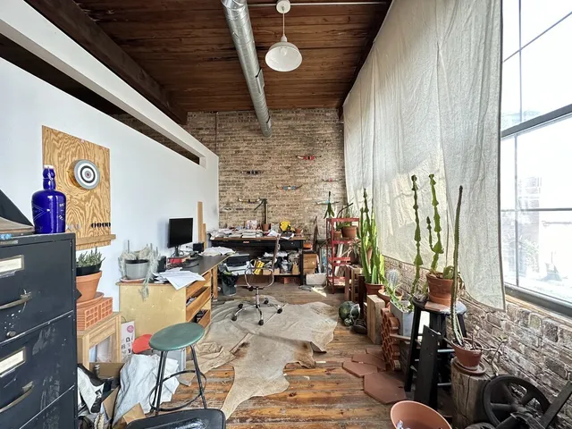 a living room with patio furniture and a large window