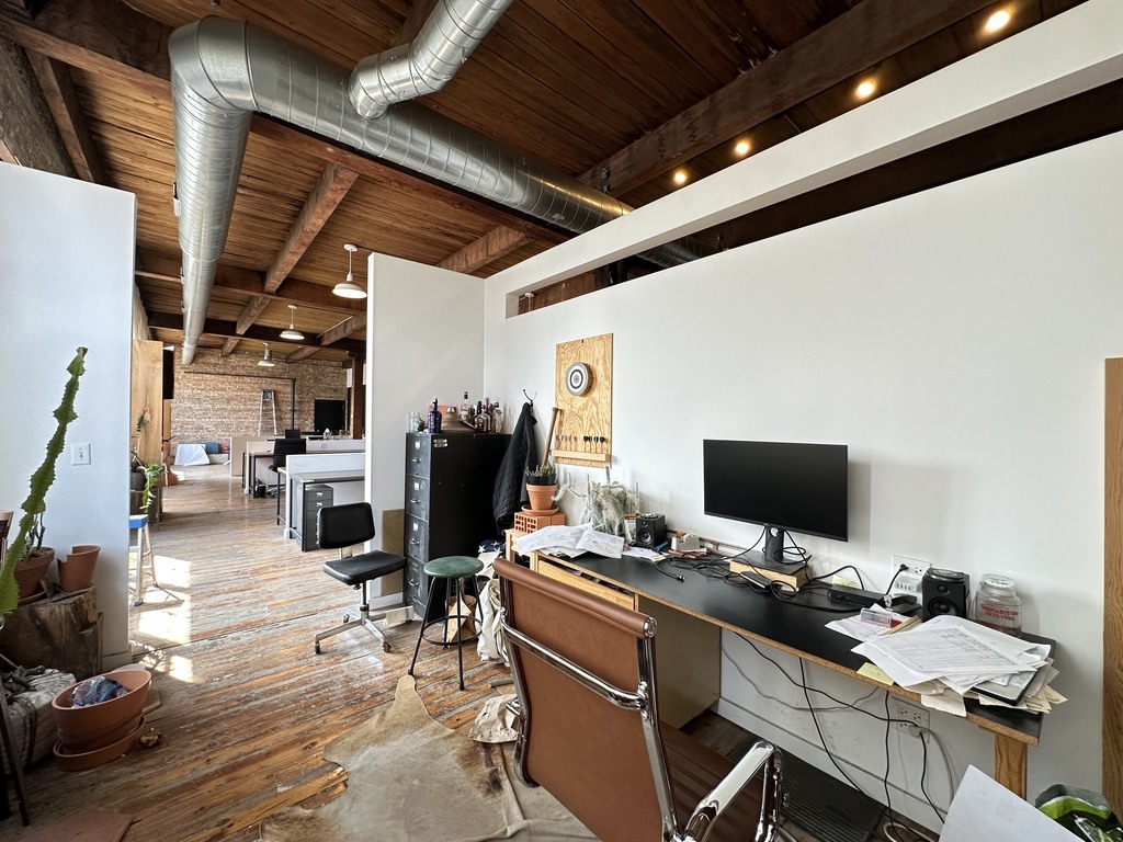3124 West Carroll Avenue, Unit 2F Chicago, IL 60612 - Photo 6 of 20 a view of a workspace with furniture and a rug