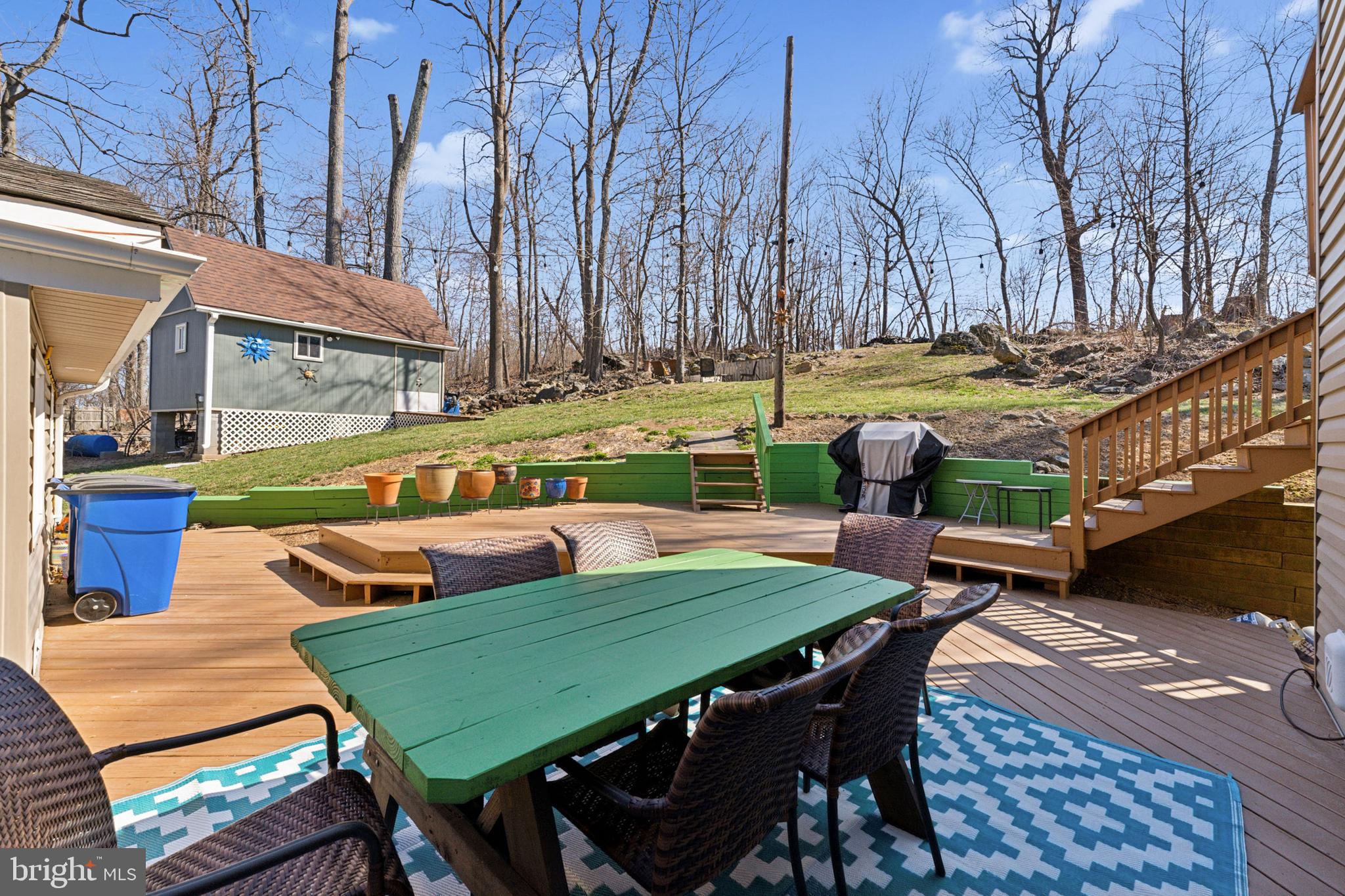 44 Luchase Road Linden, VA 22642 - Photo 33 of 52 a view of a patio with table and chairs couches under an umbrella with a fire pit