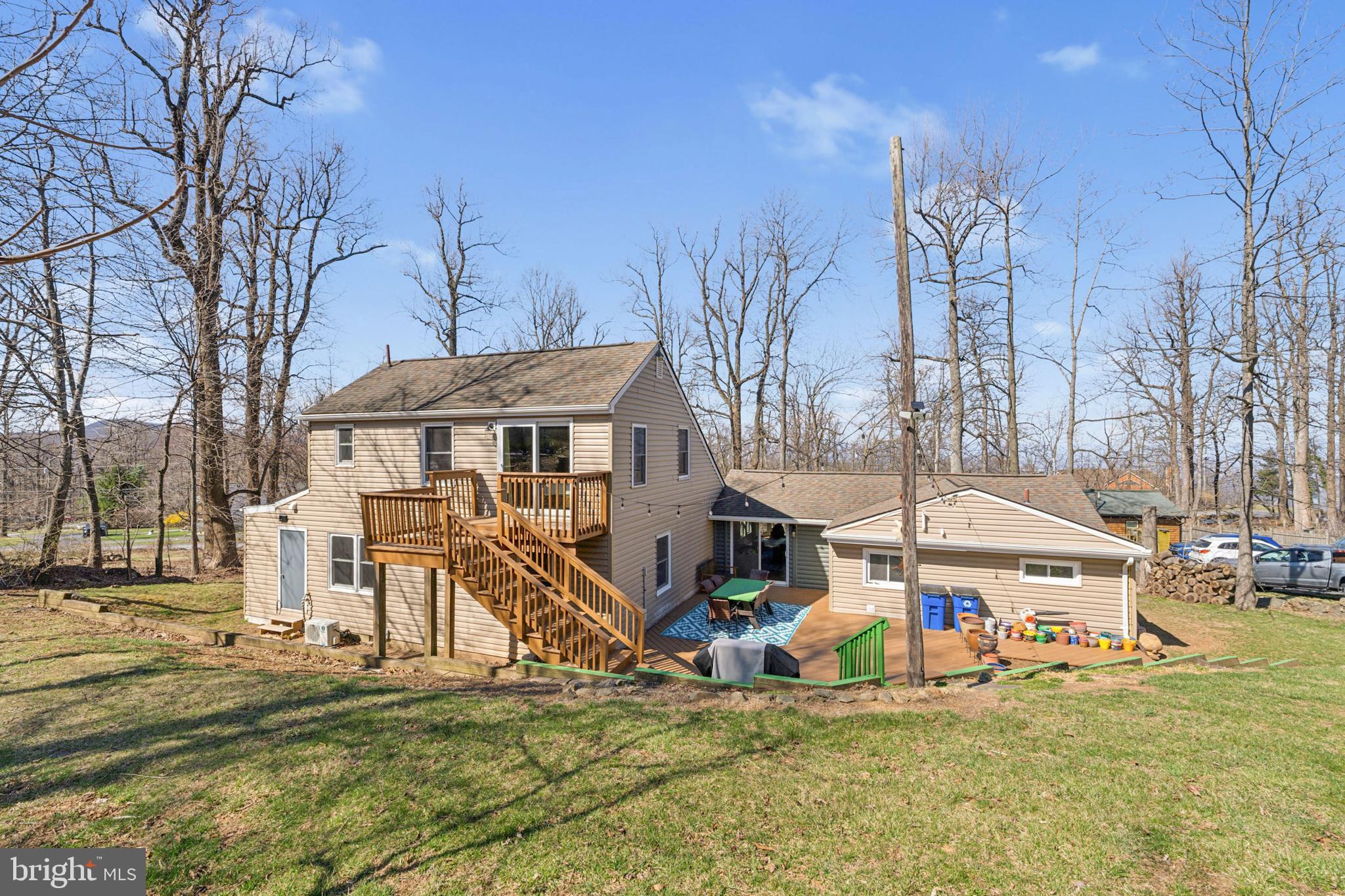 44 Luchase Road Linden, VA 22642 - Photo 41 of 52 a view of a white house with large trees and park