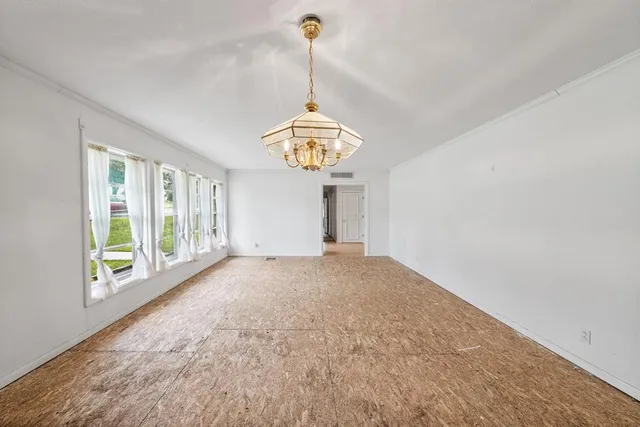 an empty room with a empty space and windows