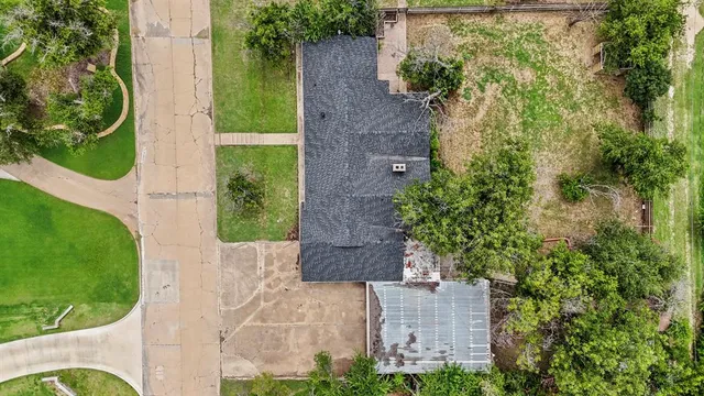 an aerial view of a house with a yard
