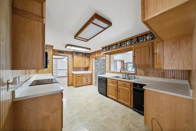 a kitchen with granite countertop a sink and cabinets