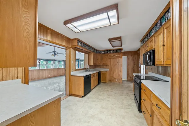 a kitchen with stainless steel appliances granite countertop a sink and a stove