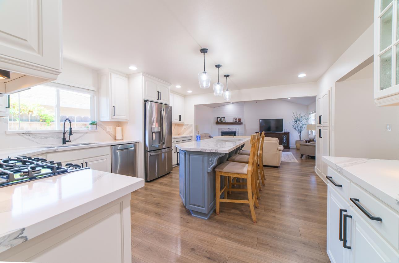 731 La Mesa Drive Salinas, CA 93901 - Photo 15 of 43 a kitchen with stainless steel appliances kitchen island granite countertop a table chairs stove and refrigerator