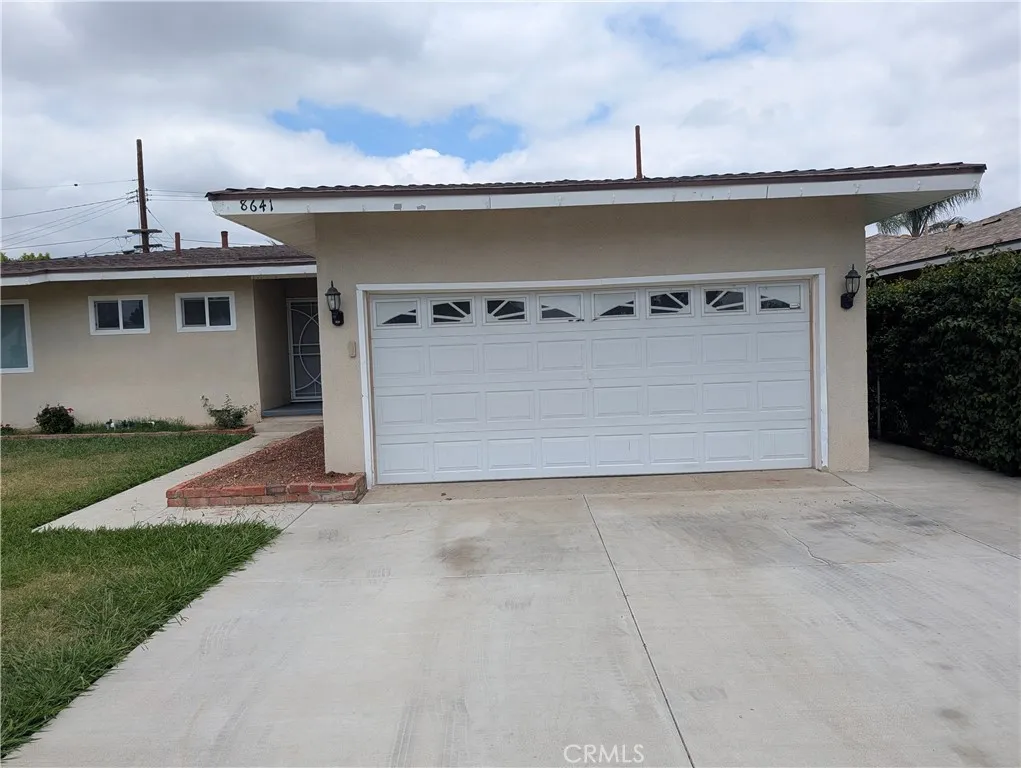 8641 Garfield Street, Unit 1 Riverside, CA 92504 - Photo 2 of 19 a front view of a house with garden