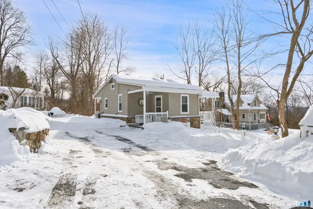 a view of a house with a yard covered in snow