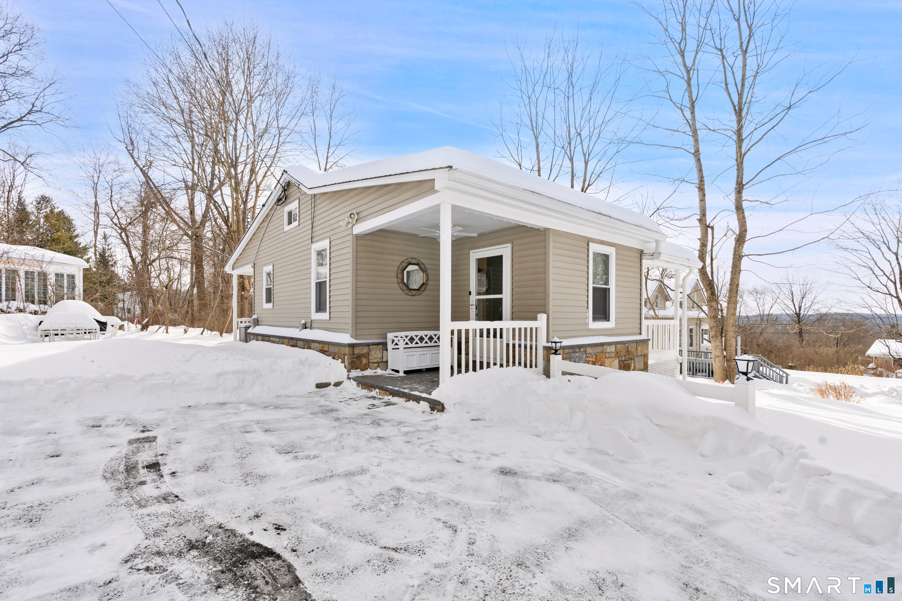 14 Bantam Road New Fairfield, CT 06812 - Photo 32 of 42 a view of a white house with a yard covered in snow