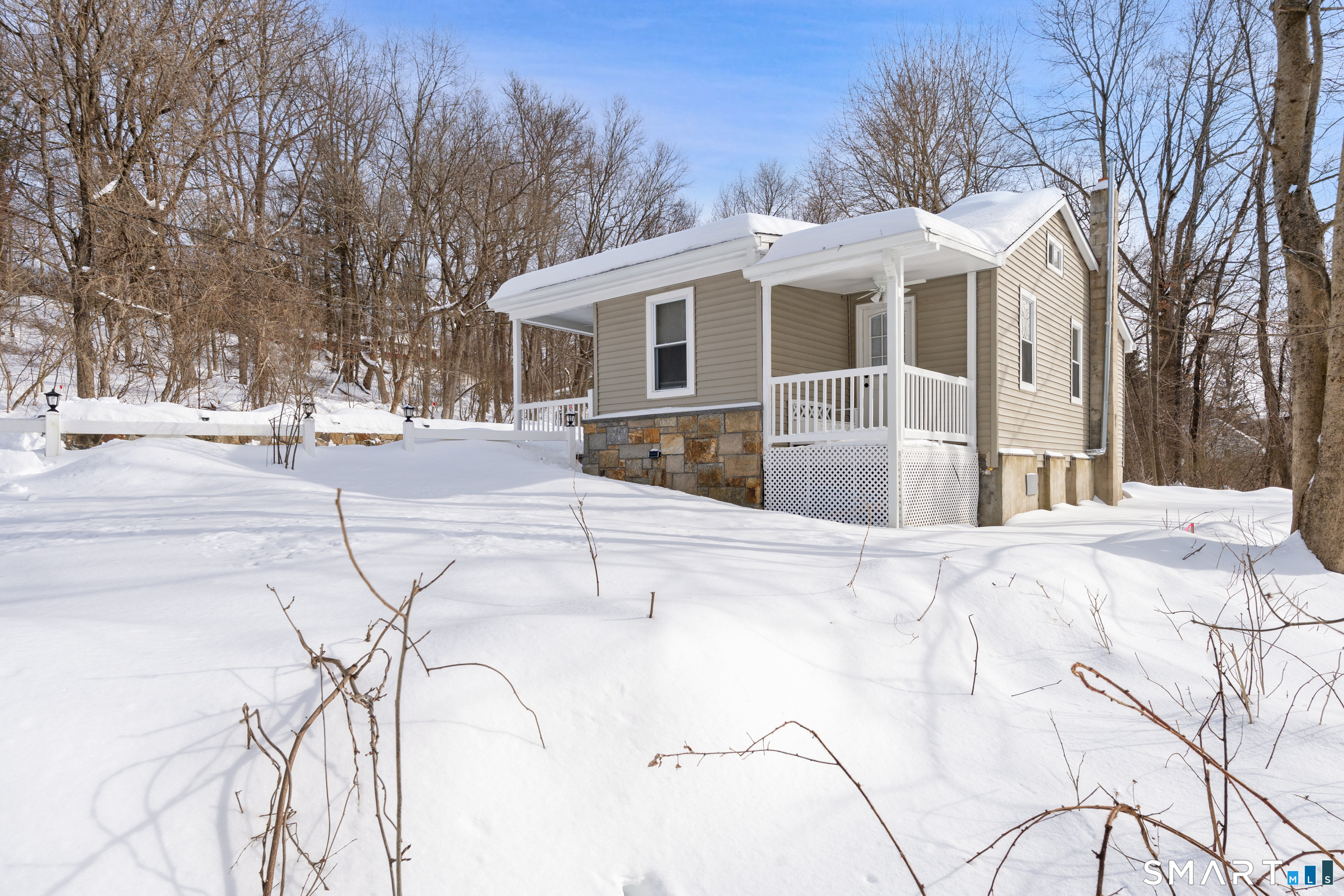 14 Bantam Road New Fairfield, CT 06812 - Photo 36 of 42 a front view of a house with a yard covered in snow