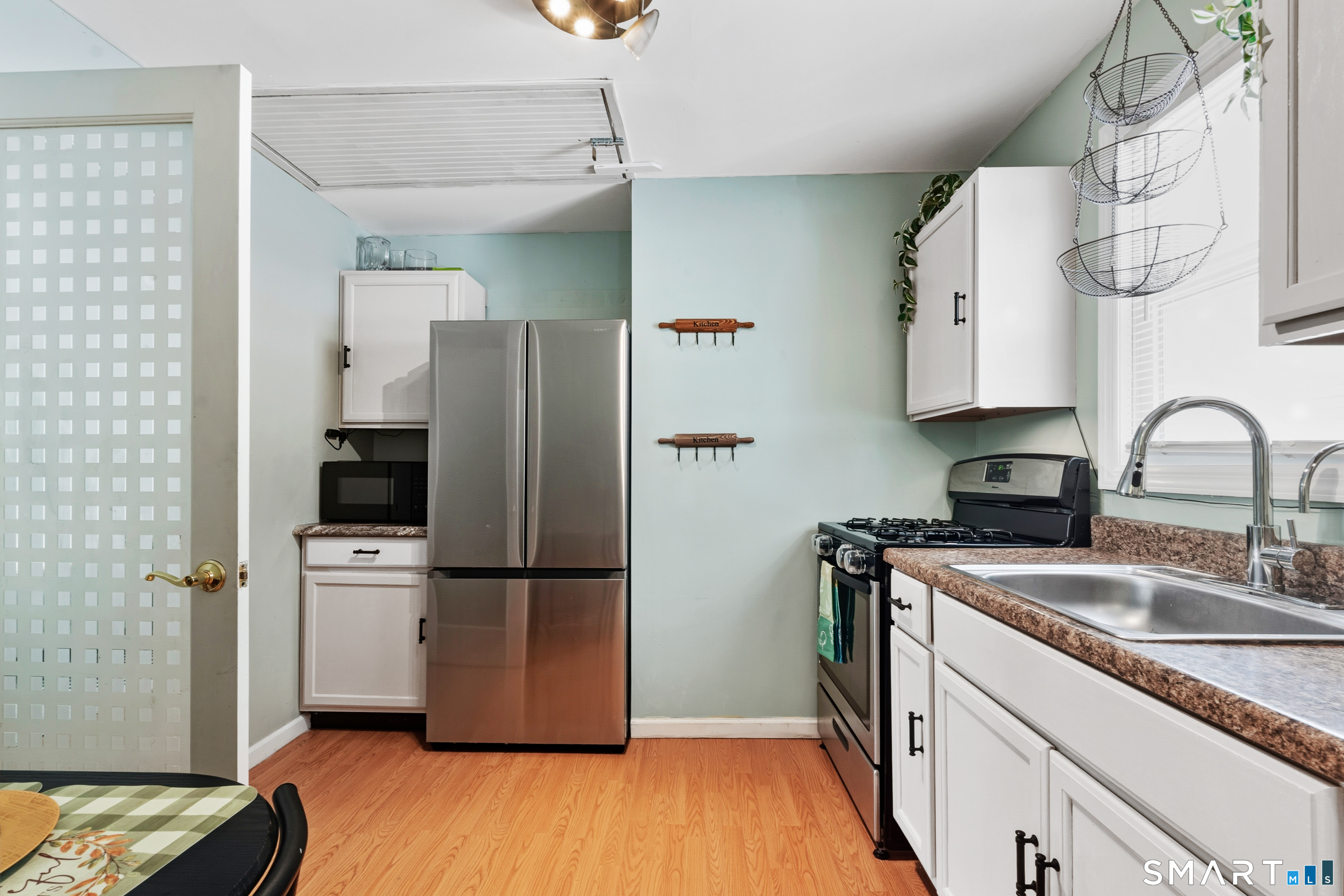 14 Bantam Road New Fairfield, CT 06812 - Photo 5 of 42 a kitchen with a refrigerator sink and wooden floor