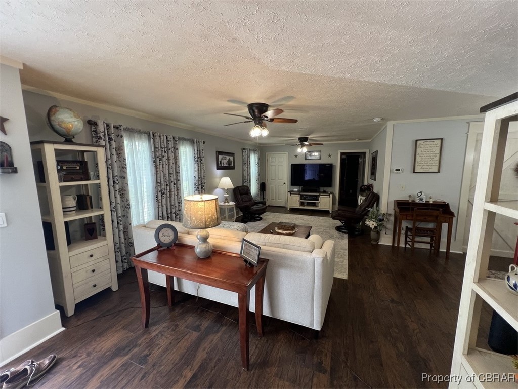 102 Mechams Cove Road Topping, VA 23169 - Photo 24 of 40 Living area with a textured ceiling, a ceiling fan, wood finished floors, and crown molding