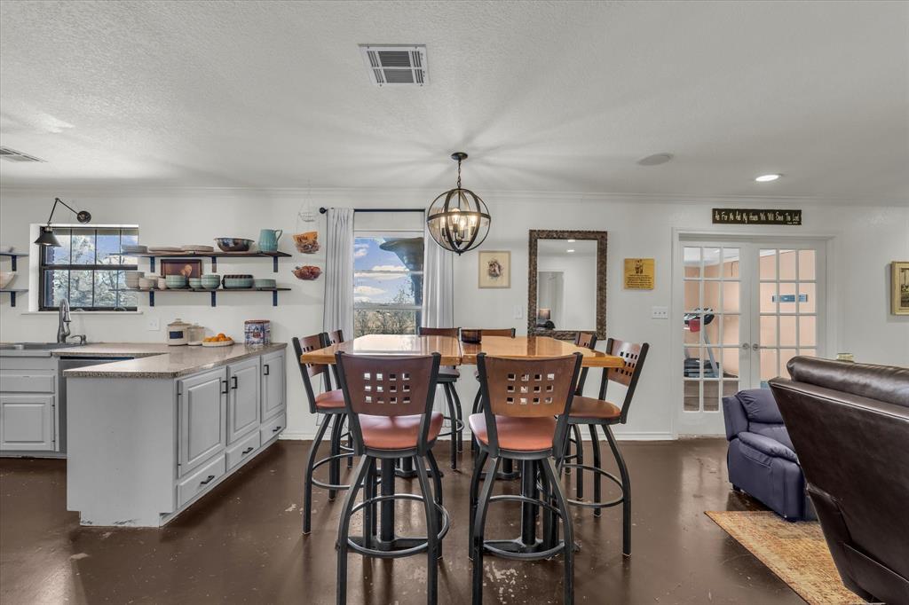 7633 South 3rd St Road Waco, TX 76706 - Photo 11 of 33 a view of a dining room with furniture window and wooden floor