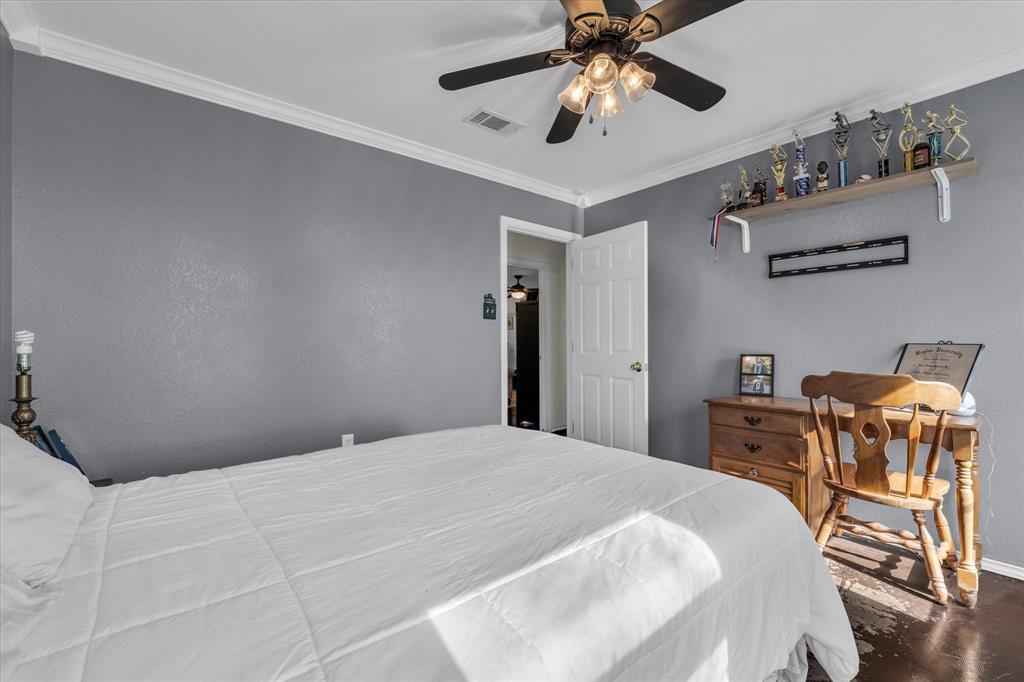 7633 South 3rd St Road Waco, TX 76706 - Photo 18 of 33 a bedroom with a bed and a chandelier