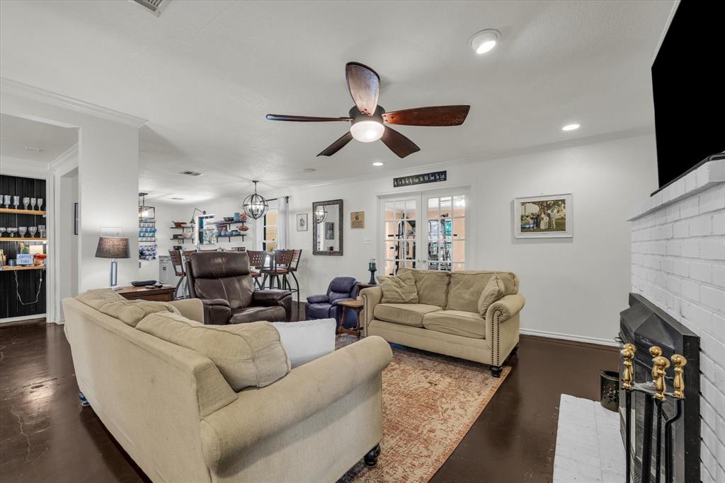 7633 South 3rd St Road Waco, TX 76706 - Photo 6 of 33 a living room with furniture a ceiling fan and a fireplace