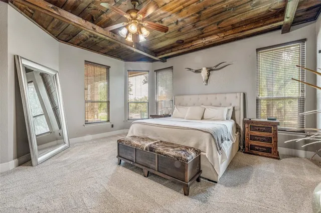 a spacious bedroom with a bed and a chandelier